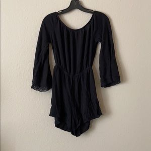 Black off the shoulder romper sleeve detailing.